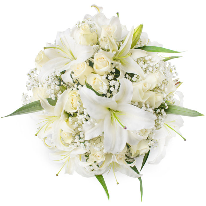 Taken from an overhead viewpoint on a bright white surface, this perfectly balanced round bouquet presents a quiet study in white florals and subtle greenery. Several large white lilies dominate the scene with broad, gently curving petals and visible pale green and yellow stamens that add a touch of botanical realism to the composition. Interspersed among these lilies are numerous cream-to-ivory roses in various stages of opening - many tightly furled, others showing concentric layers of velvety petals that create depth and a tactile softness. Fine sprays of white Baby's Breath nestle between the larger flowers, giving the arrangement an ethereal, cloud-like texture and helping to maintain a dense, even profile. Small glossy green leaves peek out at the bouquet's rim, providing a fresh, cool contrast to the monochrome palette and reinforcing the circular shape. The lighting is soft and even, accentuating the satin sheen of petals and the delicate shadows between layers, evoking a sense of calm and dignified celebration. Imagined for occasions ranging from an elegant riverside wedding near Westminster Bridge to a sympathetic tribute placed in a quiet chapel off Charing Cross Road, this bouquet speaks of purity, renewal, and careful craftsmanship - a classic choice for clients who seek timeless beauty in central London's historic neighbourhoods like Covent Garden and the Strand.