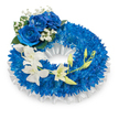 A serene, circular funeral wreath composed of a dense ring of deep blue chrysanthemum heads sits against a pristine white backdrop, its texture rich and almost tactile. The tiny, tightly layered petals of the blue mums form a full, voluminous band that reads as a field of midnight and sapphire tones; their quietly complex scent is softened here by cool, diffused light, giving the composition a calm, contemplative feel. Nestled at the upper-left curve are three large, fully opened blue roses whose velvety petals catch subtle highlights, their sapphire depth harmonising with the chrysanthemum base. Around these roses, airy sprays of tiny white baby's breath and a few dark green leaves punctuate the blue with delicate, lace-like accents. Tracing the inner edge of the wreath, a ruffled white satin ribbon provides a soft, pleated frame that lifts and defines the circle, its smooth sheen contrasting with the chrysanthemums' fine texture. From the mid-left the design gently flows downward and across to the lower right in a graceful cascade of ivory-white orchid blooms-likely Phalaenopsis or a similar variety-whose broad, silky petals and pale centres offer an ethereal counterpoint to the deep blues. Interspersed among the orchids are fresh, chartreuse-green buds at various stages of opening, a subtle reminder of renewal and continuance within a tribute of remembrance. The overall palette of royal blues and pure whites, balanced with dark foliage and satin highlights, conveys dignity, solace, and quiet respect-an arrangement intended to honour a loved one with understated elegance and heartfelt sympathy in the heart of central London.