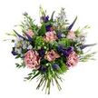 A hand-tied bouquet that reads like a quiet stroll through a sunlit Charing Cross garden, presented against a clean white backdrop so each colour and texture stands out. At the centre, soft antique-pink roses sit in various stages of bloom-some tightly furled, others unfurling to reveal slightly deeper rose-pink edges-their velvety petals catching a pale, morning-like light. Beside them, two full mauve-pink carnations offer ruffled, theatrical volume, their layered petals creating a tactile contrast to the roses' smooth curves. Slender spires of deep indigo to violet veronica push upward through the arrangement, providing vertical rhythm and a jewel-toned counterpoint. Scattered throughout are airy sprays of light lavender-blue aster-like flowers with tiny yellow eyes, lending a wildflower looseness and a soft, meadowish quality. Deeper purple lisianthus buds and small blooms add jewel-rich punctuation, while rounded, silvery-green eucalyptus leaves and bright lime-green clusters of textural filler tuck in as a verdant, cooling backbone. Slender green leaves and new buds peek from between blooms, enhancing the organic, just-gathered-from-the-border feeling. The stems are visible and gathered at the base, clearly hand-tied, the natural taper of stems forming a relaxed, tapered silhouette that would sit equally well on a café table by the Strand or a mantel near Trafalgar Square. The overall effect is gentle and uplifting-fresh, fragrant in a subtle way, and perfectly suited for birthday greetings, a thoughtful thank-you, or to brighten a small Charing Cross flat with the enduring charm of seasonal, garden-inspired blooms.